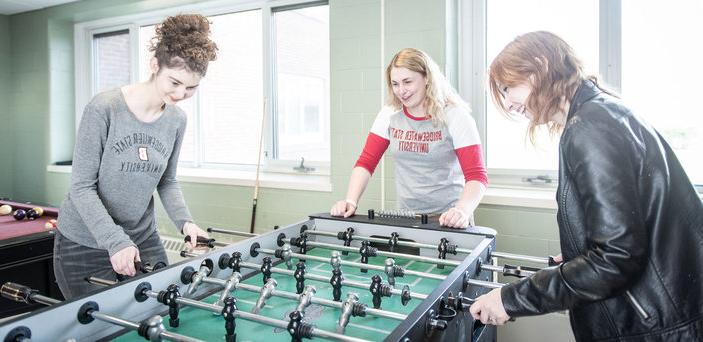 Students play foosball together in the game room